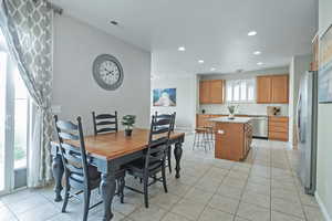 Dining area featuring light tile patterned floors and recessed lighting