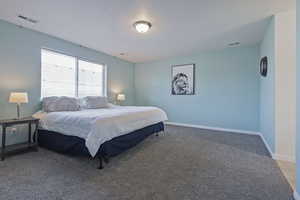 Bedroom featuring carpet flooring and baseboards