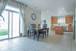Dining space featuring light tile patterned flooring and recessed lighting
