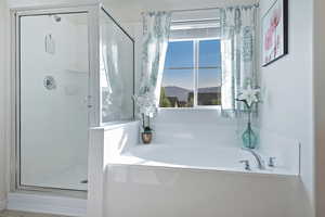Bathroom featuring a shower stall and a garden tub