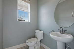 Bathroom featuring toilet and baseboards