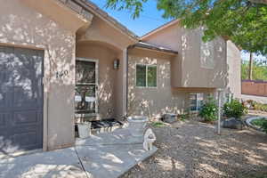 View of exterior entry featuring stucco siding