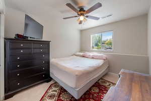 Bedroom featuring a ceiling fan and light carpet