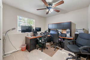 Office area featuring light carpet and ceiling fan