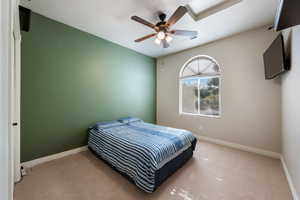Bedroom with light carpet and a ceiling fan