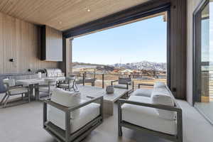 View of patio featuring a mountain view, an outdoor kitchen, and outdoor lounge area