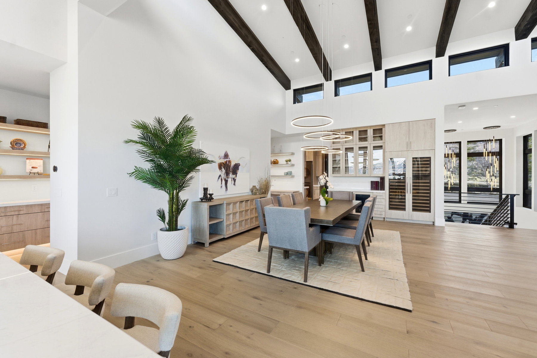 Dining room with light wood-style floors and recessed lighting