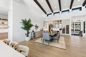 Dining room with light wood-style floors and recessed lighting