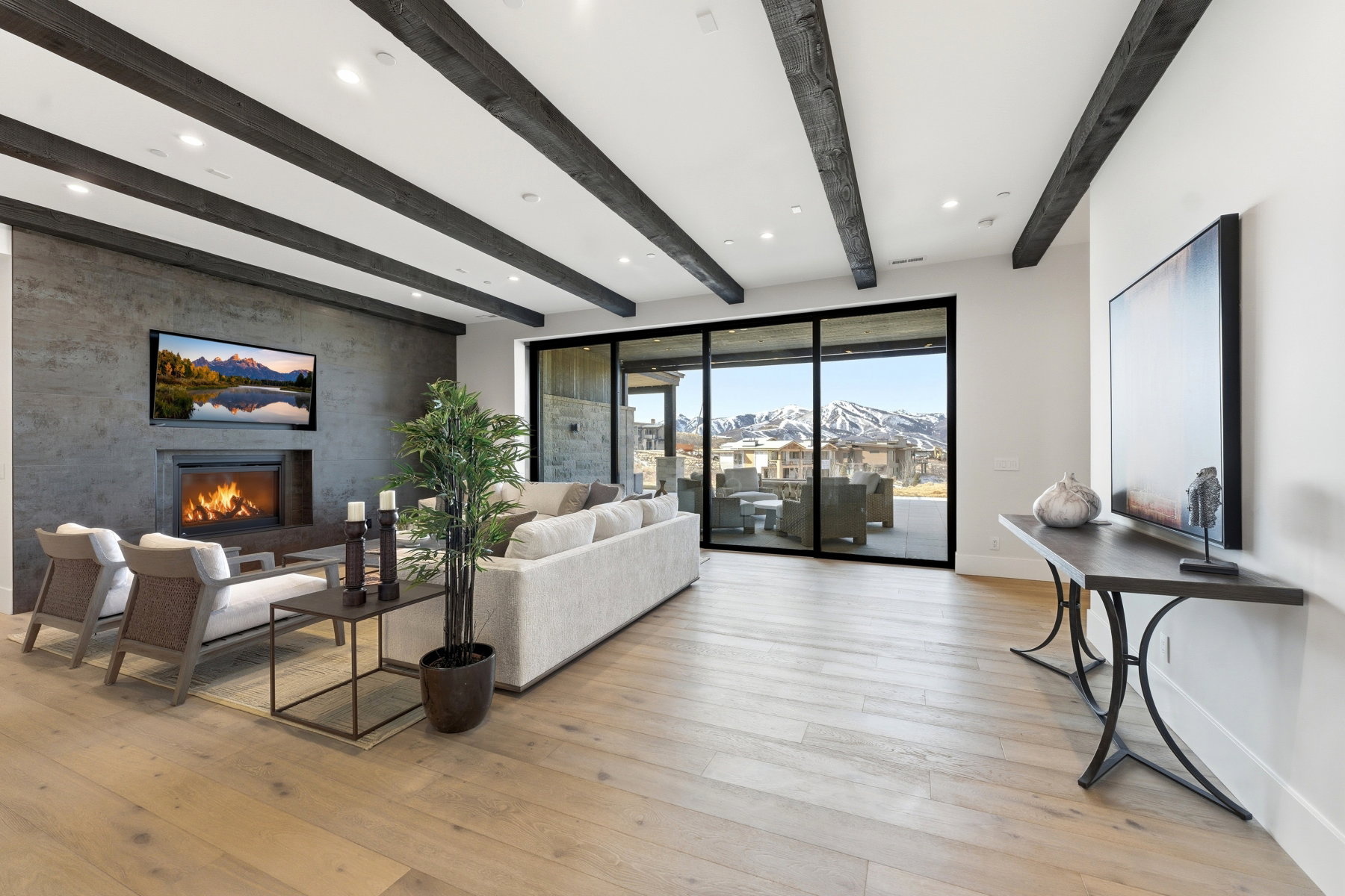 Living area featuring light wood-style flooring, a fireplace, and recessed lighting
