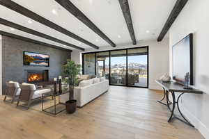 Living area featuring light wood-style flooring, a fireplace, and recessed lighting