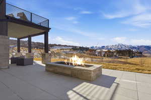 View of patio / terrace featuring a mountain view and a fire pit
