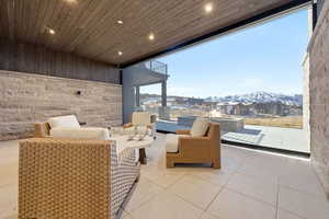 View of patio / terrace featuring a mountain view, outdoor lounge area, and a residential view