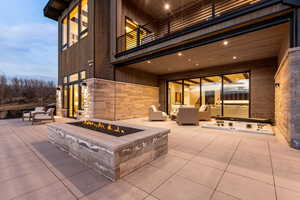Patio / terrace with an outdoor living space with a fire pit, a patio area, and an outdoor hot tub