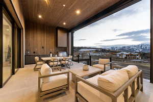 Balcony featuring a mountain view and an outdoor kitchen with living area