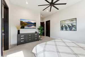 Bedroom with light carpet, a ceiling fan, and recessed lighting