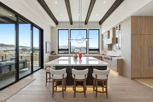 Dining room featuring beamed ceiling, a mountain view, light wood finished floors, and recessed lighting