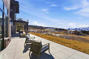 View of patio with a fire pit, a mountain view, and a residential view