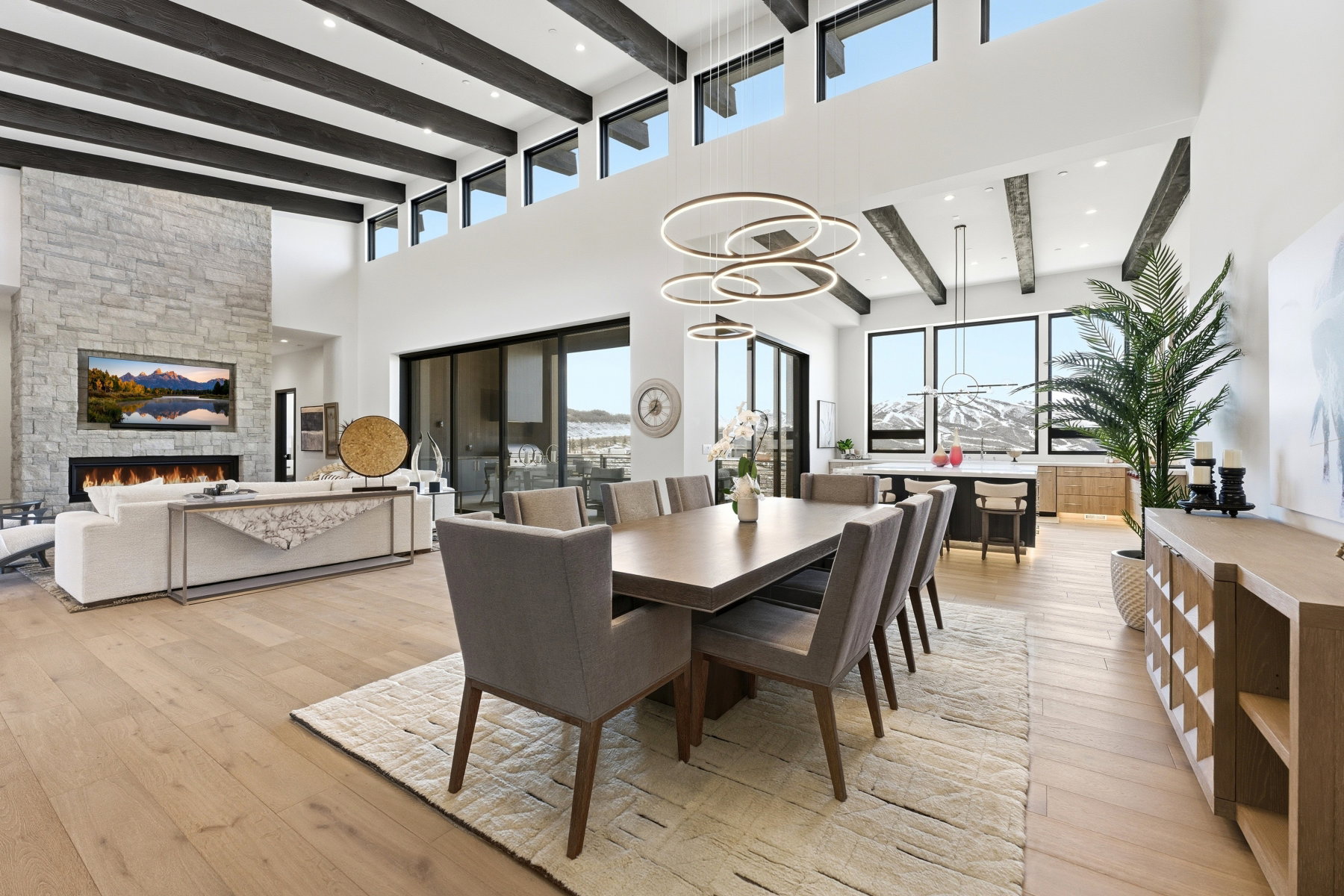 Dining area featuring light wood-style floors, a fireplace, recessed lighting, and plenty of natural light