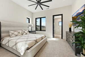 Bedroom with light carpet, a ceiling fan, and ensuite bath