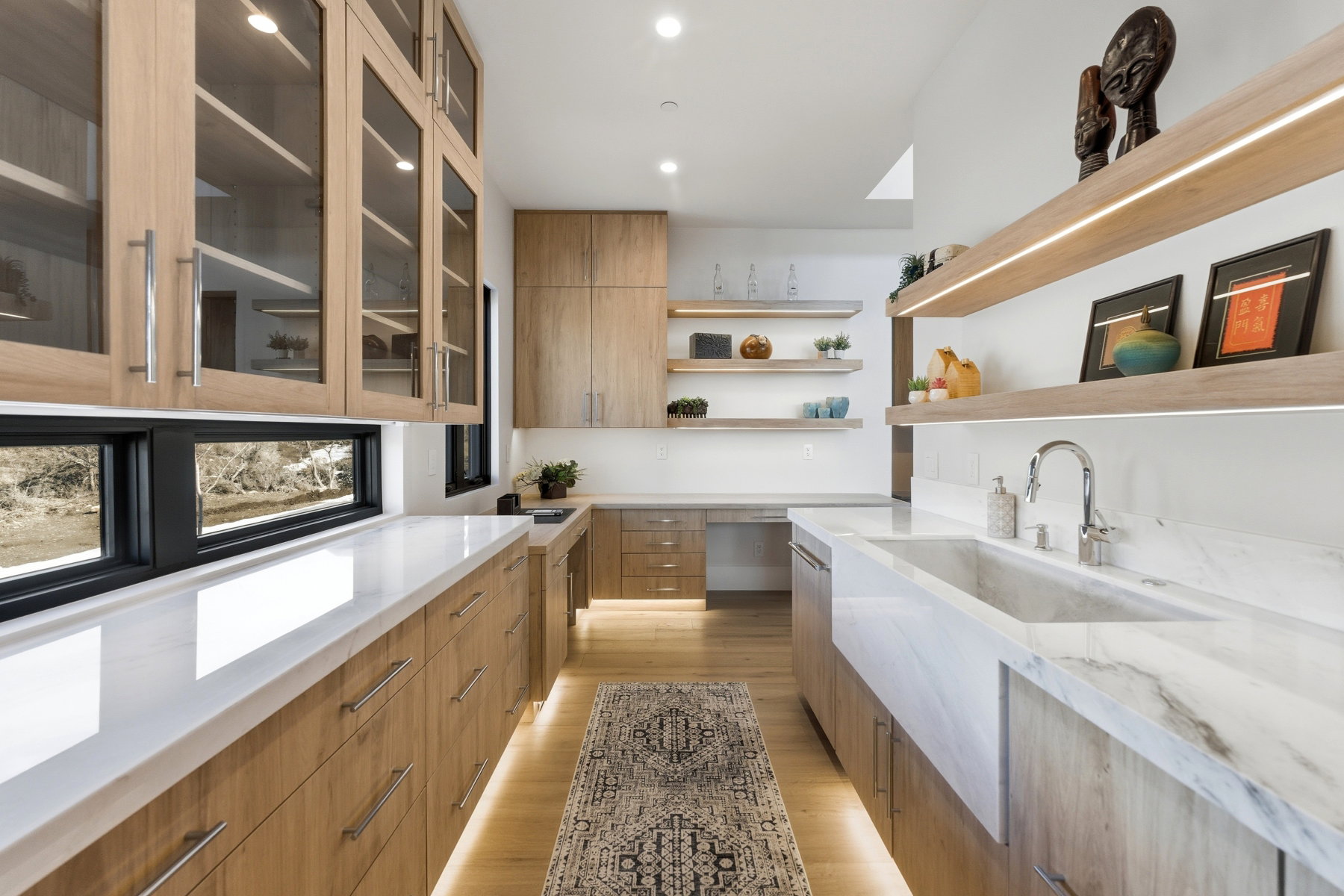 Kitchen featuring modern cabinets, light stone counters, light wood-type flooring, wood finish cabinets, and recessed lighting