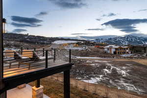 Snow covered back of property featuring a mountain view