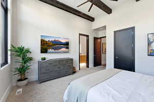 Carpeted bedroom with ceiling fan and baseboards