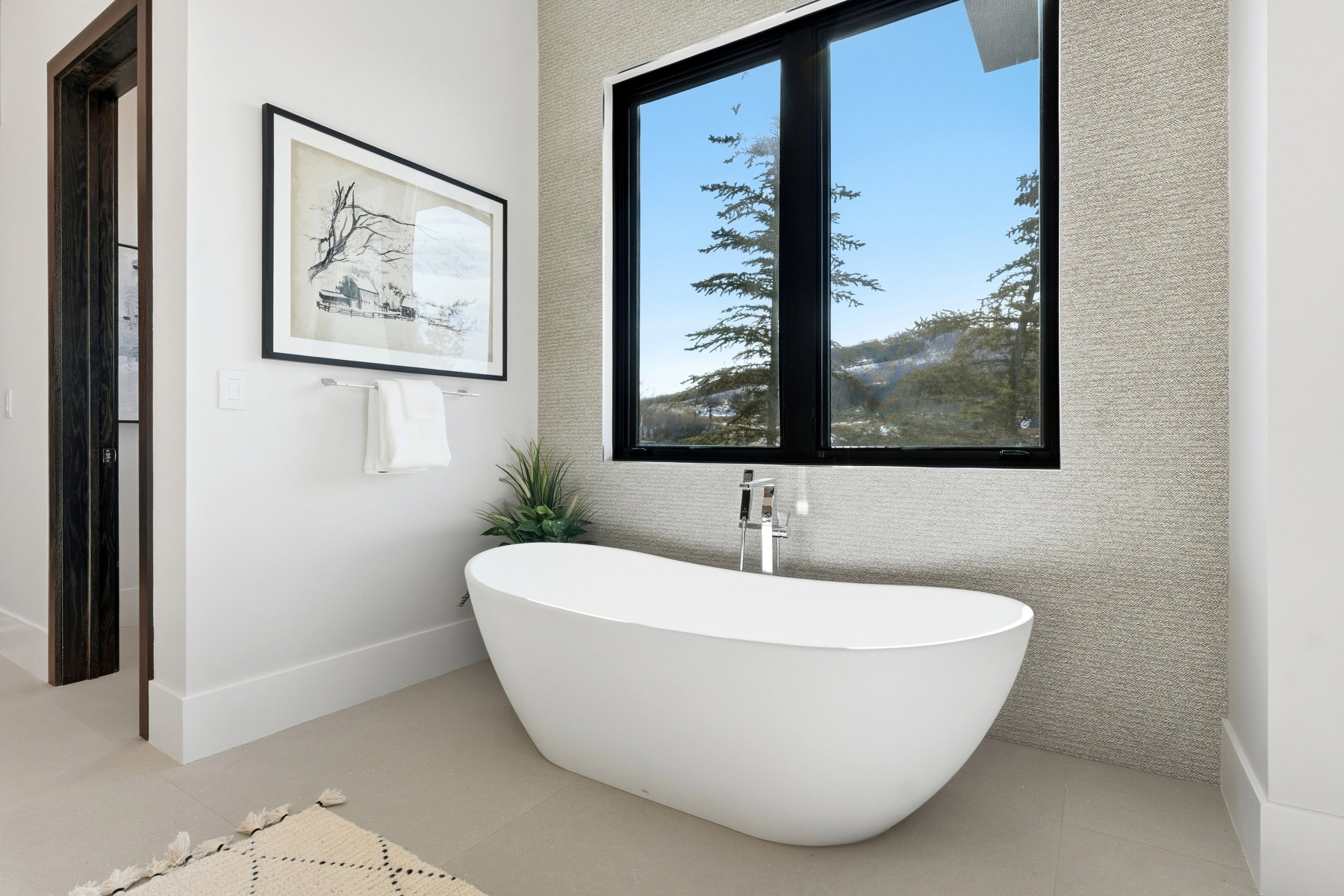 Bathroom with a freestanding tub and light tile patterned floors