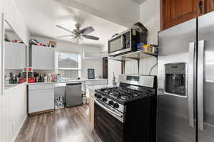 Kitchen featuring stainless steel appliances, light countertops, light wood finished floors, a ceiling fan, and white cabinets
