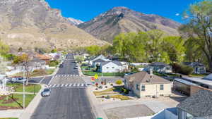 View of mountain backdrop featuring nearby suburban area