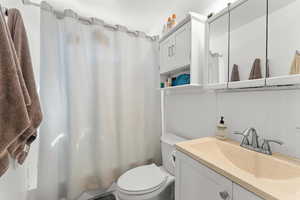 Full bath with vanity and shower / bath combination with curtain