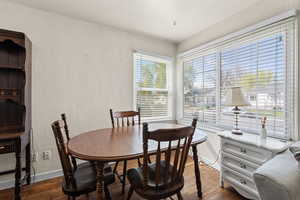 Dining room featuring dark wood-type flooring