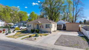 Bungalow-style home featuring driveway and a storage shed