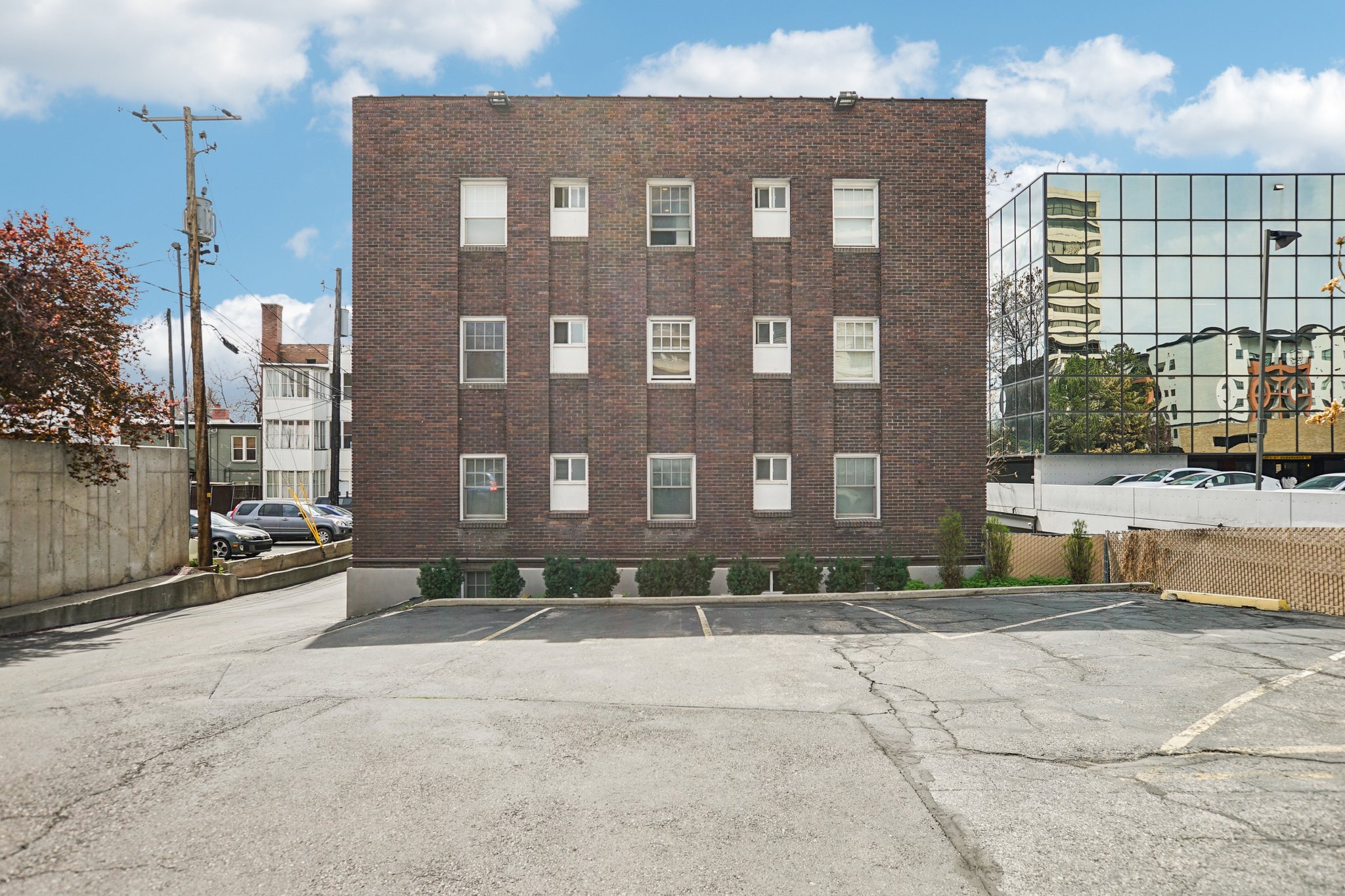 View of apartment building / complex with uncovered parking