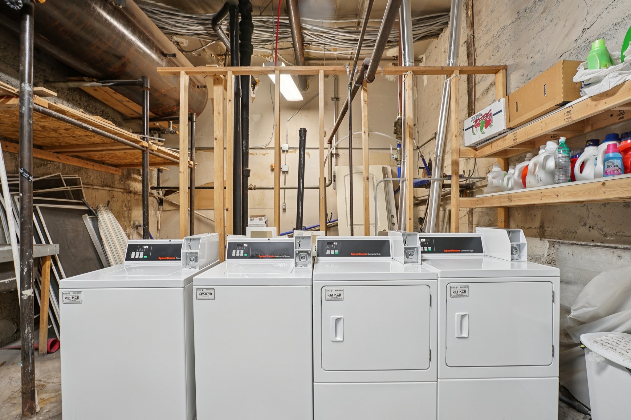 Community laundry room featuring washing machine and dryer