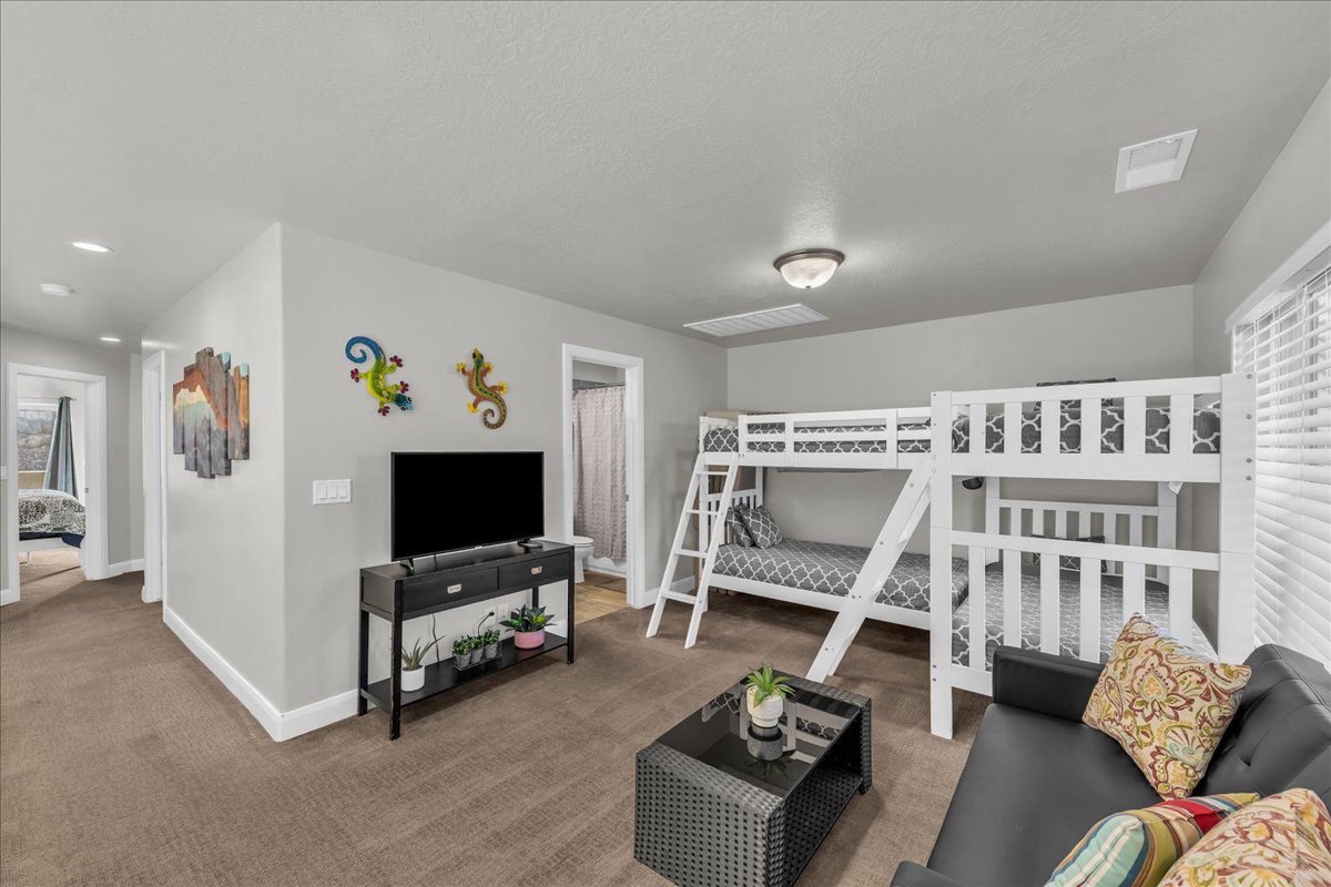 Bedroom featuring carpet floors and baseboards