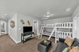 Bedroom featuring carpet floors and baseboards