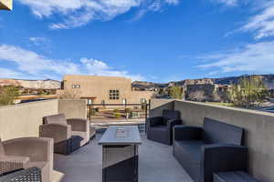 View of patio with outdoor seating, a mountain view, and a residential view