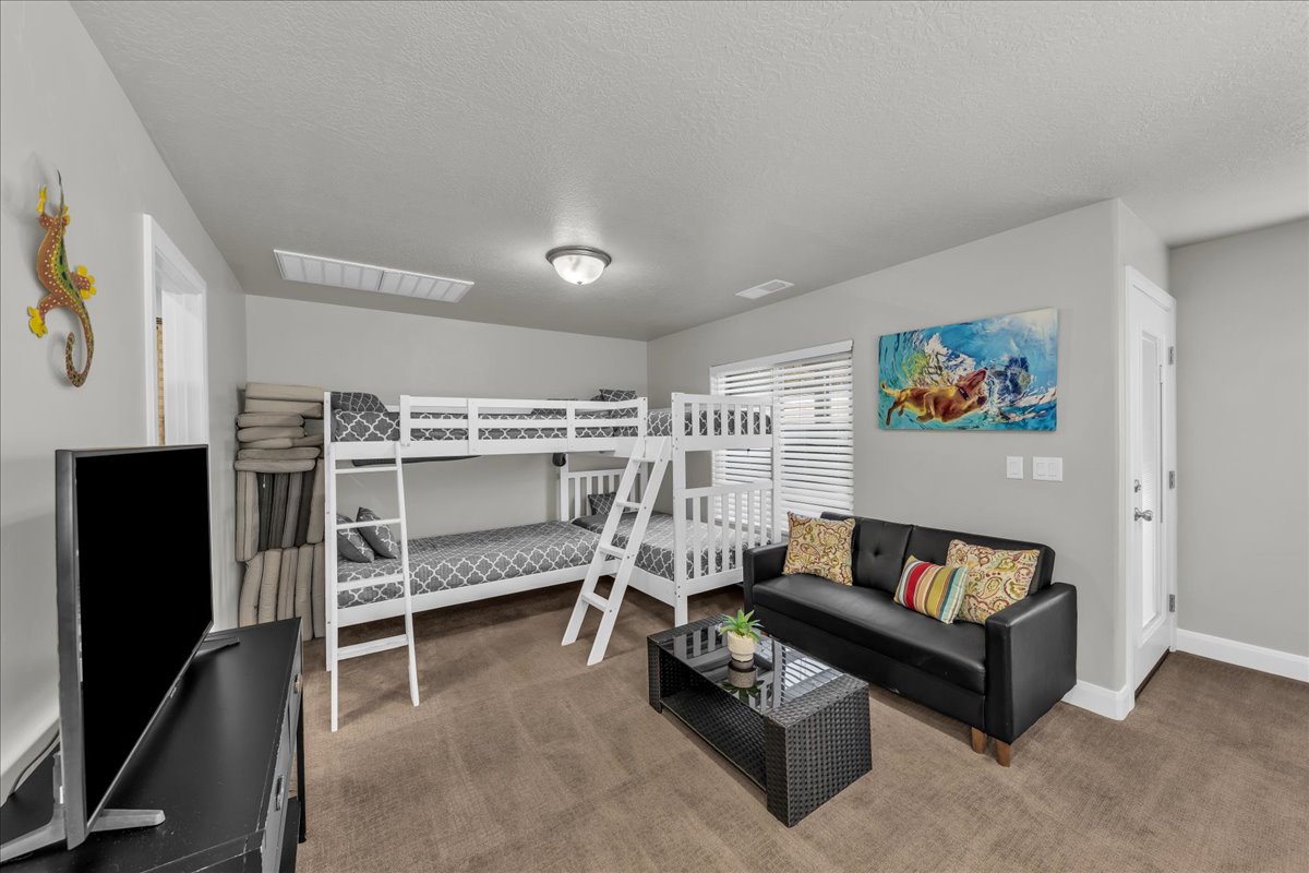 Bedroom with carpet flooring and a textured ceiling