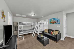 Bedroom with carpet flooring and a textured ceiling