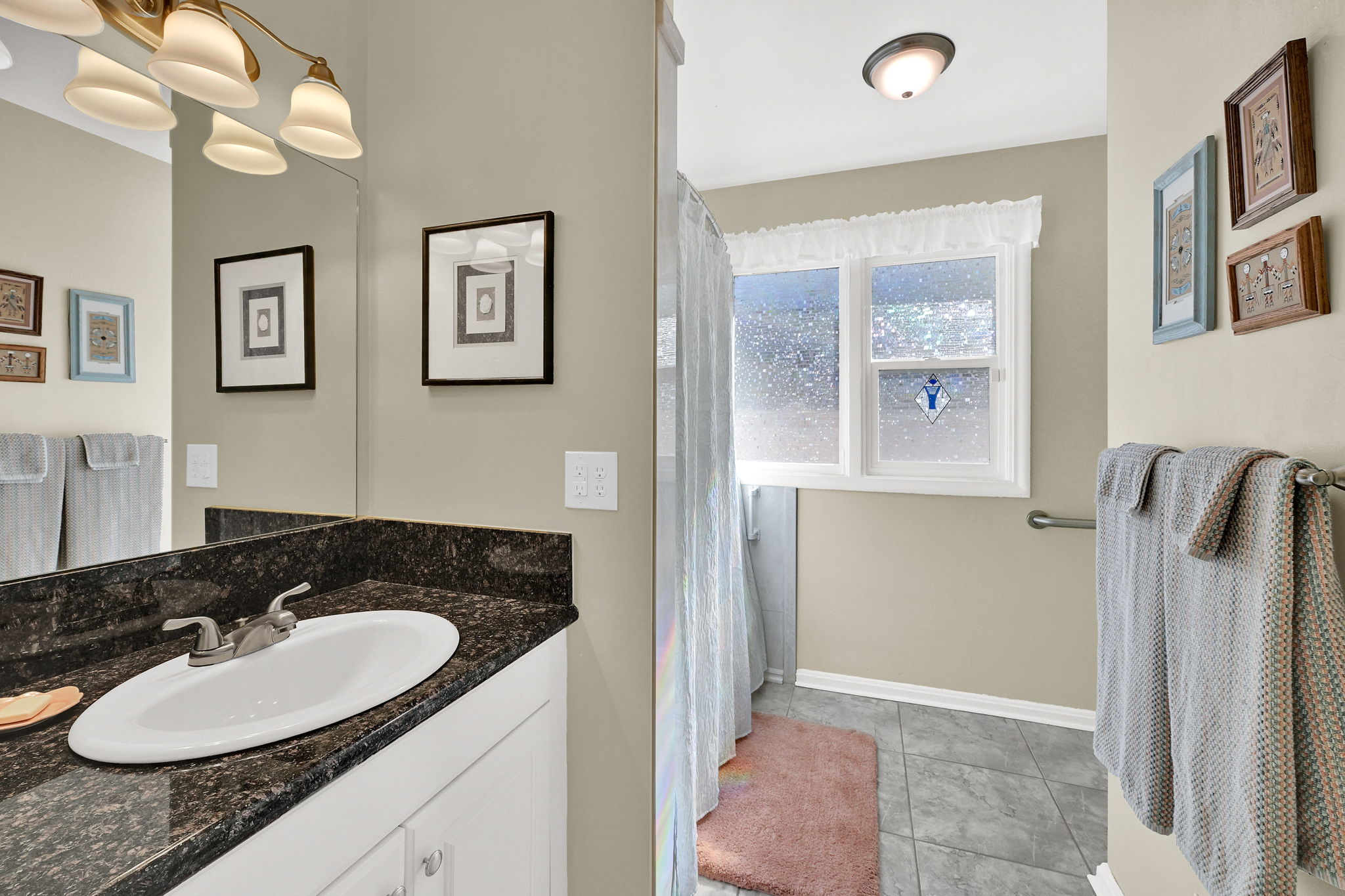 Full Bathroom with vanity, curtained shower, and storage