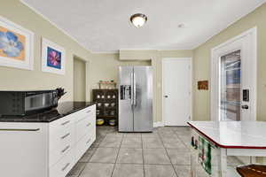 Kitchen featuring stainless steel appliances, updated white cabinetry, a large pantry, and granite counters.