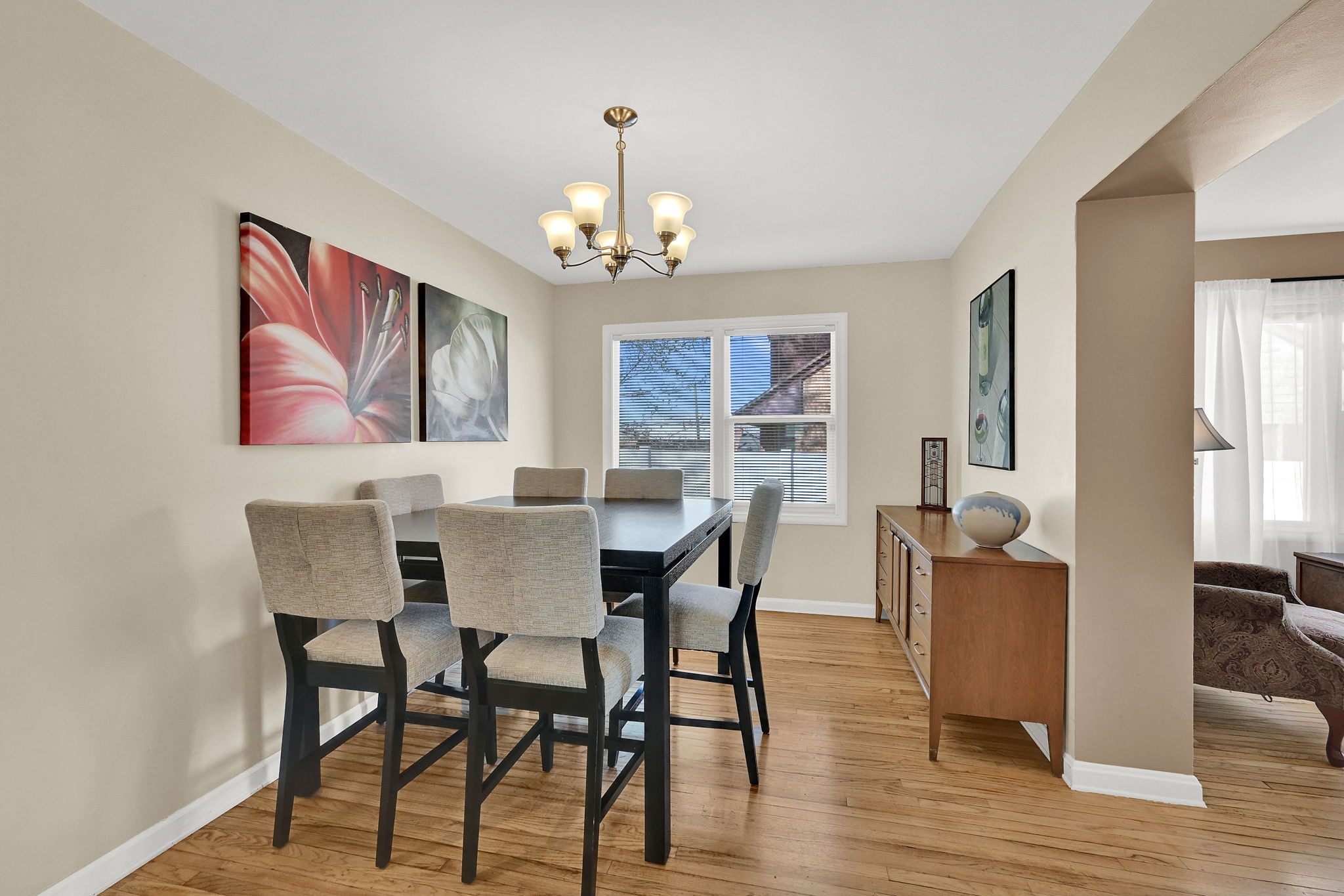 Semi-formal dining space featuring wood flooring and a chandelier