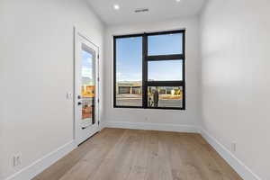 Spare room with light wood-style flooring and recessed lighting