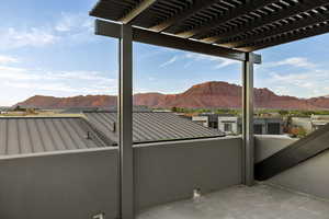 View of patio with a mountain view and a pergola