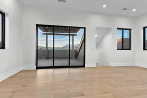 Unfurnished room with light wood-style floors and recessed lighting