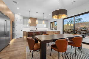 Dining area featuring light wood-style floors and recessed lighting