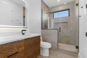 Bathroom featuring vanity, a stall shower, and light tile patterned flooring