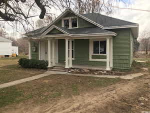 Bungalow-style house with a shingled roof and a porch