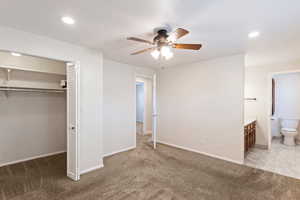 Unfurnished bedroom with connected bathroom, light carpet, ceiling fan, recessed lighting, and a closet