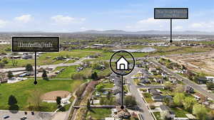 Aerial perspective of suburban area featuring a mountain backdrop